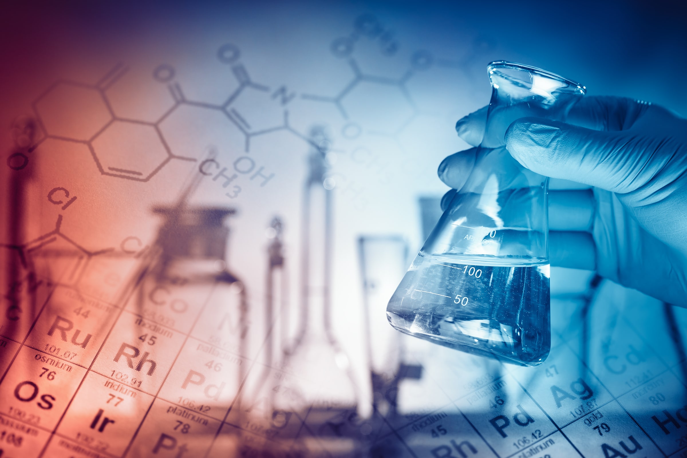 Gloved laboratory technician holding a chemical sample